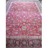 A hand knotted, woollen Kashan rug with red ground, approx. 403cm x 291cm, in good condition