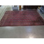 A hand knotted woollen Bokhara rug, with a red field, 300cm x 190cm - some usage wear, colours