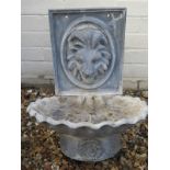 A lead lions head water feature, with shell form bowl, approx 46cm H, wear consistent with outdoor