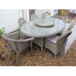 A Bramblecrest oval garden table with four single chairs and two stacking side chairs, with