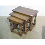 A nest of three oak tables, 48cm H x 61cm x 33cm