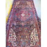 A hand knotted, woollen Hamadan rug, blue ground, approx. 305cm x 138cm, some signs of wear but in a