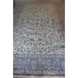 A Kashan, hand knotted, woollen rug with caucasian ground, approximately 375cm x 275cm, some light