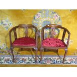 A pair of Edwardian walnut tub shape chairs