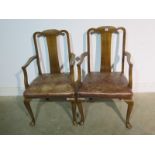 A pair of Queen Anne style elbow chairs with leather seats - removed from a Cambridge College