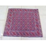 A hand knotted woollen Gazak rug - 122cm x 120cm