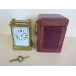 A French brass carriage clock striking on a gong with repeat, with outer case, 15cm tall, small