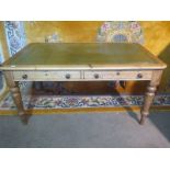 A Victorian stripped pine writing table with a leather inset top above two frieze drawers on