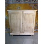 A Victorian stripped pine two door cupboard with a shelved interior - 133cm H x 123cm x 53cm