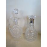 A cut glass decanter with a silver collar and a cut glass claret jug, 32cm tall - both generally