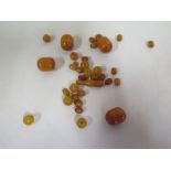 A collection of amber beads, largest 18mm x 23mm total weight approx 47 grams