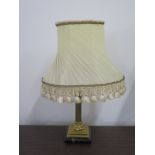 A brass table lamp with a Corinthian column mounted on an Onyx base, with period shade, 48cm H