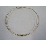 An 18ct yellow gold double wire collar, 125mm wide, marked Italy 750, Unoaerre approx 15.3 grams, in