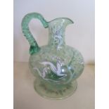 A green glass jug with stag, deer, rabbit and bird decoration, 23cm tall, generally good with