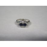 An 18ct white gold sapphire and diamond ring, approx 5.1 grams, size P, with some surface wear
