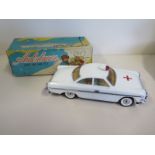 A Retro tin plate battery powered ambulance car with original box, no makers name but features