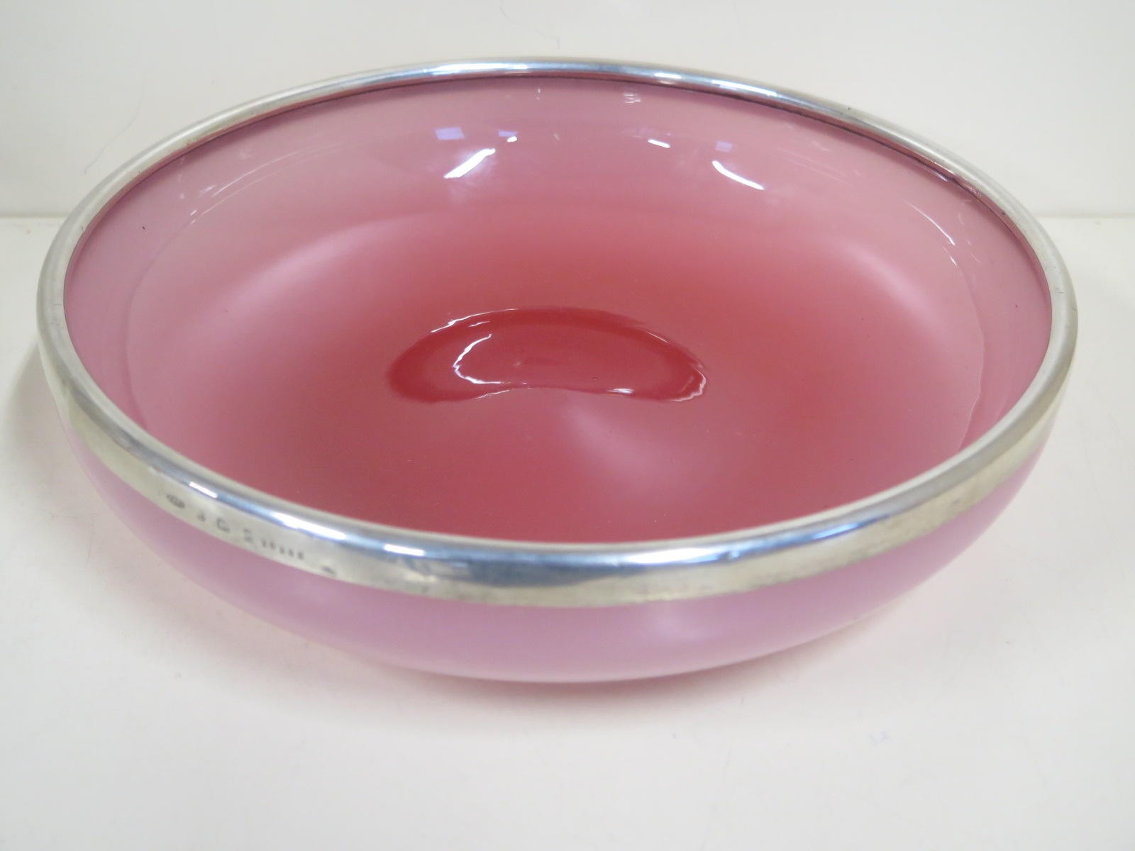 An early 1900s pink Vaseline glass circular bowl having a silver rim with hallmarks for Birmingham
