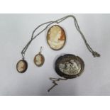 Two cameo brooches and two cameo pendants, largest pendant 6cm x 4cm