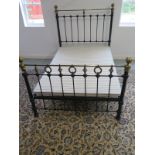 A Victorian style brass and iron 4'6" double bed with wooden fabric covered base headboard 144cm