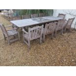 A Barlow Tyrie Waveney good quality teak extending garden table and 10 armchairs, table extends to 3