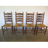 As set of four oak ladder back dining chairs with rush seats, all in sturdy condition