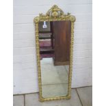 A modern gilt embossed framed mirror, 101cm H x 37cm W