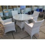 A Bramblecrest Atlanta table 120cm diameter, four armchairs, parasol and base