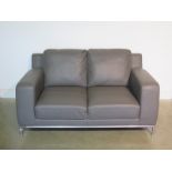 A new Furniture Village faux grey leather and chrome two seater linea sofa - 80cm H x 155cm W x 91cm