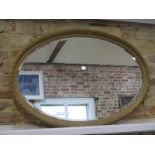 An early 20th Century gilt oval mirror, 92cm x 62cm