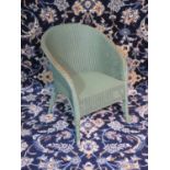 A green Lloyd Loom chair, some wear but sturdy