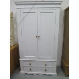 A Shabby Chic painted wardrobe with a shelved interior to one side and hanging to the other, over