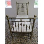 A Victorian style brass single 3 foot bed with wooden fabric covered base, headboard 142cm tall