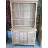 A modern beech dresser with a shelved top over base with drawers and cupboard doors, W97cm x H67cm