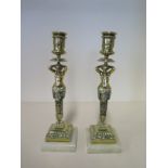 A pair of figural brass candlesticks on marble bases, 26cm H, in generally good polished