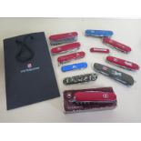 Eleven assorted Victorinox Swiss army knives plus a catalogue - generally in good condition but with