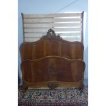 A Continental walnut double bed 159cm H x 154cm W with slatted base