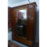 A Continental walnut single door wardrobe with a base drawer - 219cm H x 151cm x 49cm