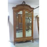 A 19th Century walnut armoire with two arch mirrored doors, 267cm H x 134cm x 50cm