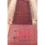 Two small hand knotted rugs, woollen rugs, both with red ground, largest approx 188cm x 185.5cm -