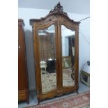 A 19th Century walnut armoire with two arched mirrored doors - 260cm H x 139cm x 49cm