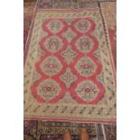 A hand knotted woollen rug with a pink field - 240cm x 150cm - colours bright, some staining to