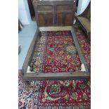 An 18th Century oak bed with a carved headboard - 114cm H x 123cm W x 176cm L