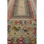 Two small hand knotted woollen rugs decorated with abstract animals, smallest 115cm x 77cm - both