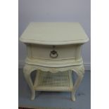 A cream painted bedside chest