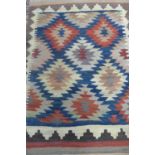 A hand knotted woollen rug with bold geometric design, approx 177cmx 120cm, colours bright but