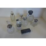 A collection of silver topped cut glass dressing table items, including large embossed silver