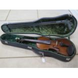 An early 20th Century violin with bow and later hard case, violin approx 60cm long overall, in