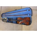 An early 20th Century violin with two bows and a hard case, a good restoration project with violin