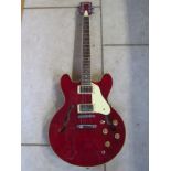 A Tanglewood Memphis semi-electric guitar with two humbucker pick ups, locking tuners, cherry red