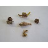 Five 9ct gold charms, including an articulated fish, a Mexican with a hidden guitar, two carriages